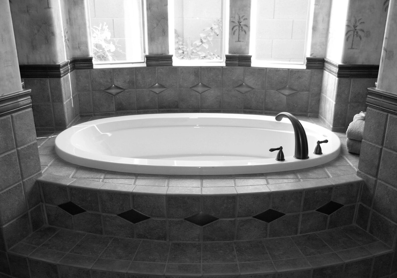 Oval built-in bathtub with tiled surround